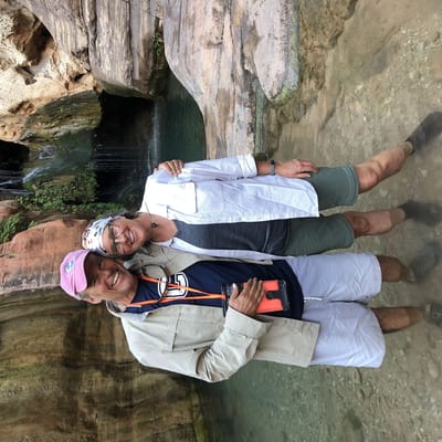 Standing in Water Near Waterfall